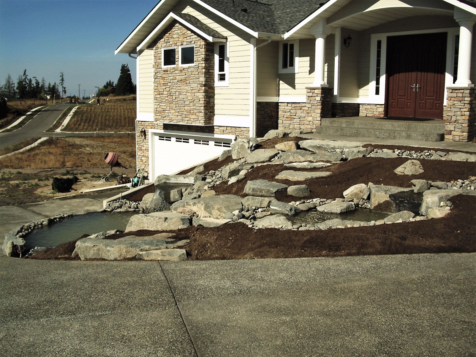 Stone water feature with landscaping